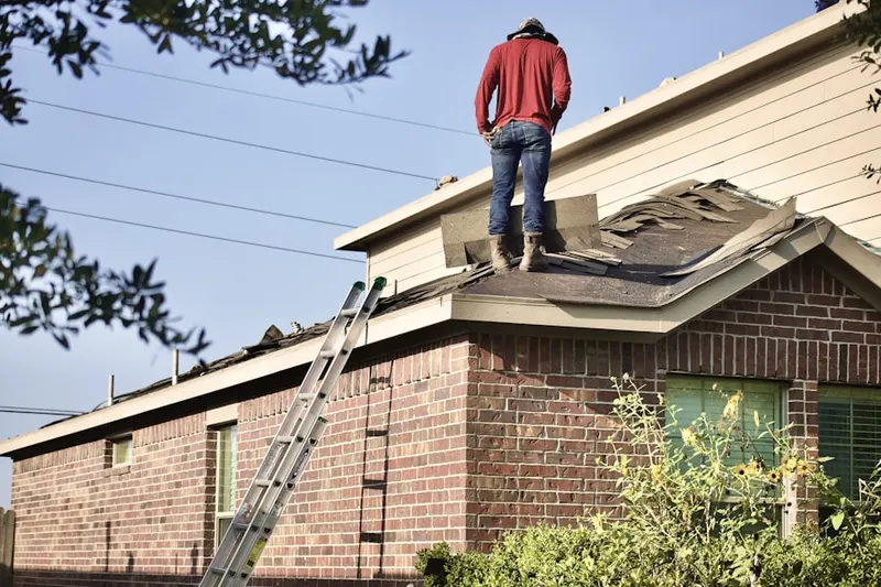 Professional roofer working on a residential roof in Downtown Coeur d'Alene